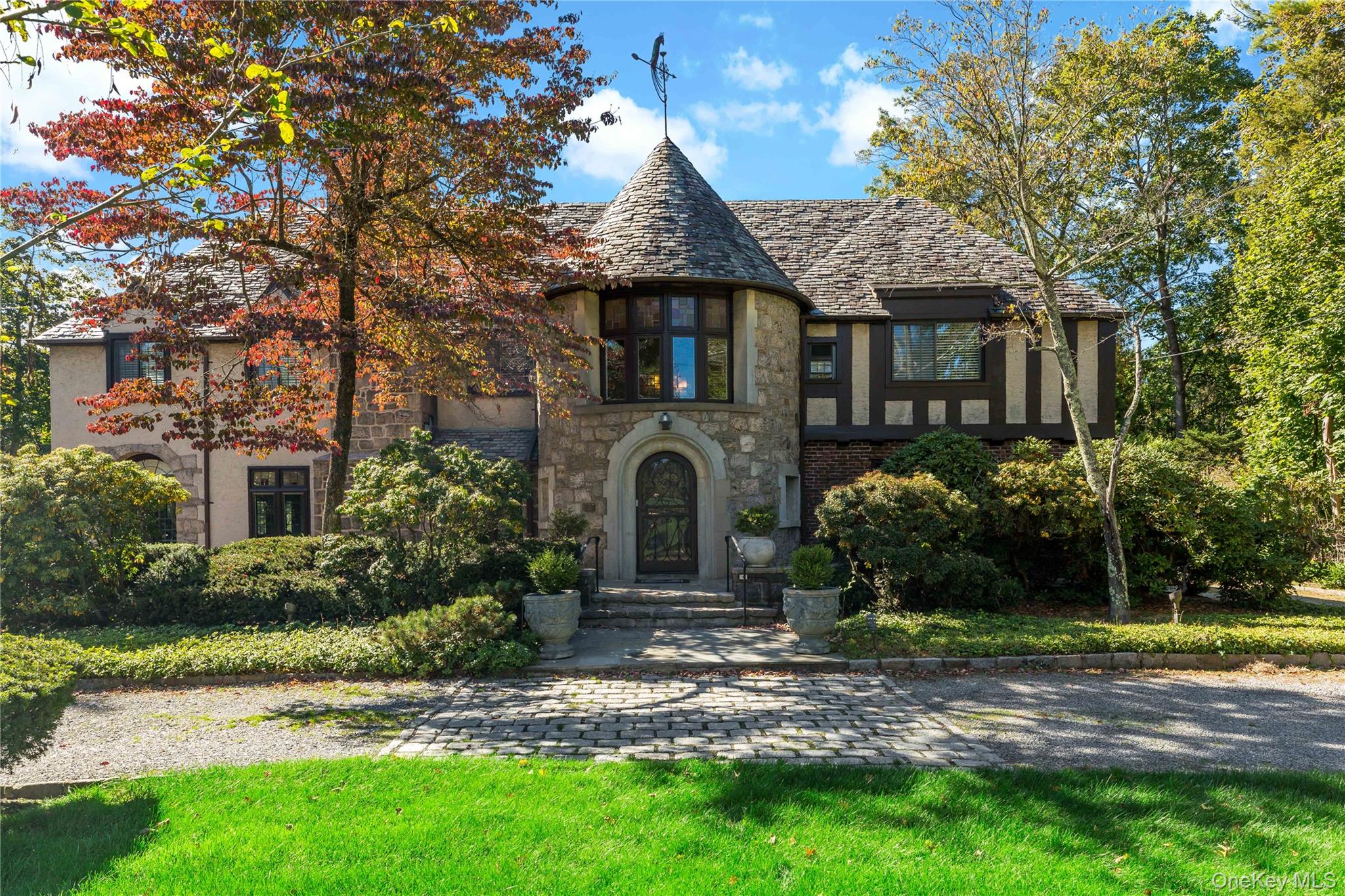 66 Mamaroneck Road Scarsdale, NY 10583 - Photo 2 of 47 Classic Normandy Tudor architecture shines with its turreted façade, leaded windows, and timeless stone detailing—an unforgettable first impression.