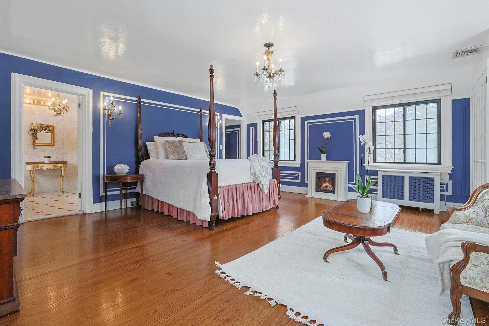 66 Mamaroneck Road Scarsdale, NY 10583 - Photo 21 of 47 A gracious primary bedroom retreat featuring generous proportions, hardwood floors, and multiple windows that fill the space with natural light.