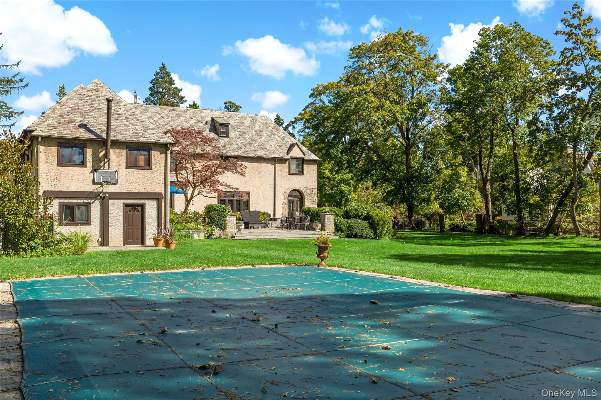 66 Mamaroneck Road Scarsdale, NY 10583 - Photo 36 of 47 The inviting inground pool is perfectly positioned for summer enjoyment, framed by sweeping green lawns and classic Tudor architecture. (Pool heat not in working order.)