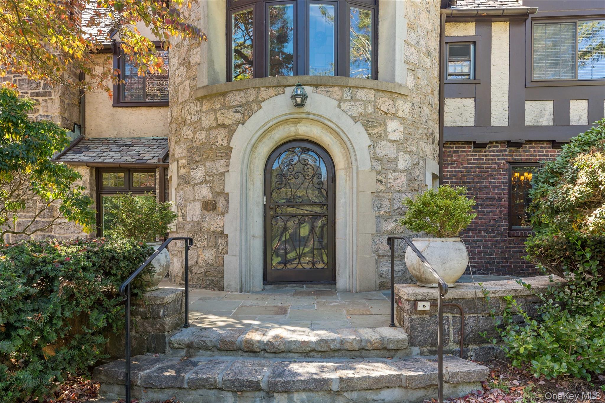 66 Mamaroneck Road Scarsdale, NY 10583 - Photo 38 of 47 A storybook stone entry with arched doorway and leaded glass door offers a warm and timeless welcome to this classic Tudor home.