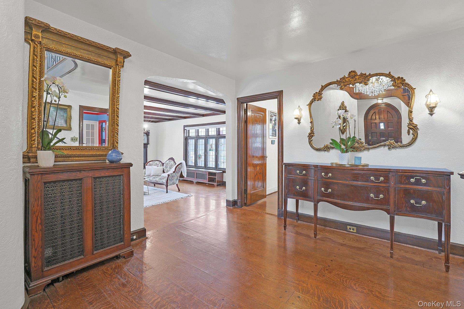 66 Mamaroneck Road Scarsdale, NY 10583 - Photo 5 of 47 The gracious foyer flows effortlessly into the main living spaces, showcasing warm hardwood floors, arched openings, and the home’s refined architectural character.