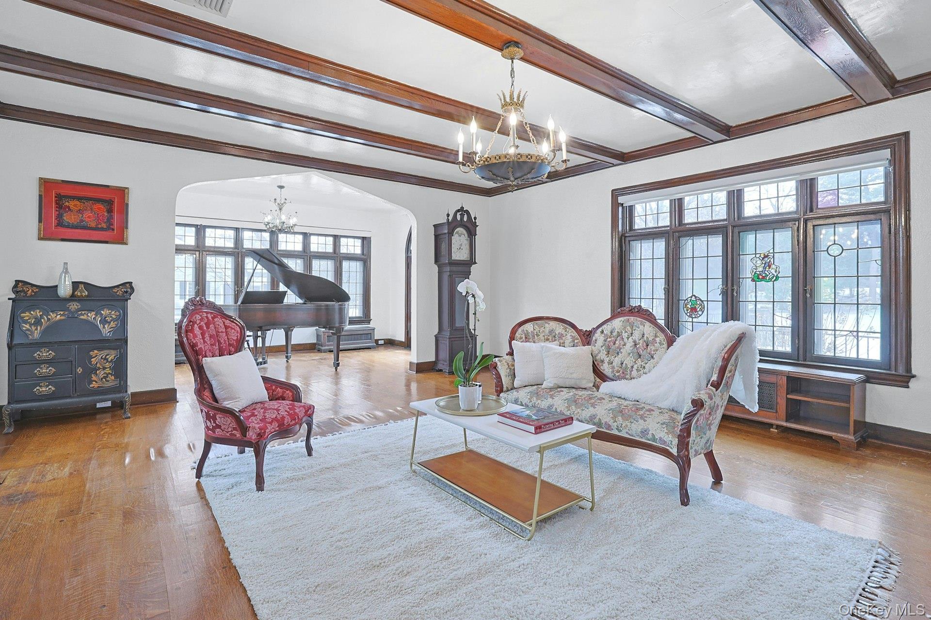 66 Mamaroneck Road Scarsdale, NY 10583 - Photo 8 of 47 Sunlight pours through multiple windows, enhancing the room’s graceful proportions and connection to the surrounding greenery.