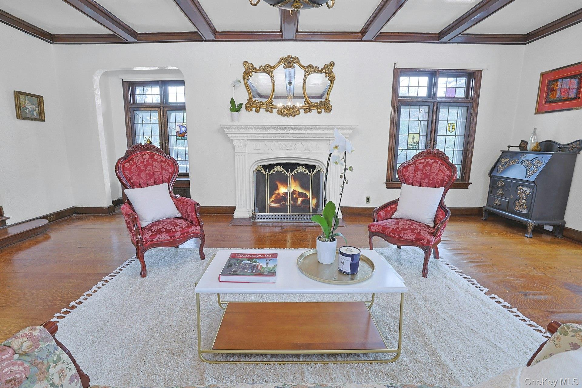 66 Mamaroneck Road Scarsdale, NY 10583 - Photo 9 of 47 The fireplace serves as a natural focal point, offering a cozy setting for intimate gatherings framed by classic Tudor charm.