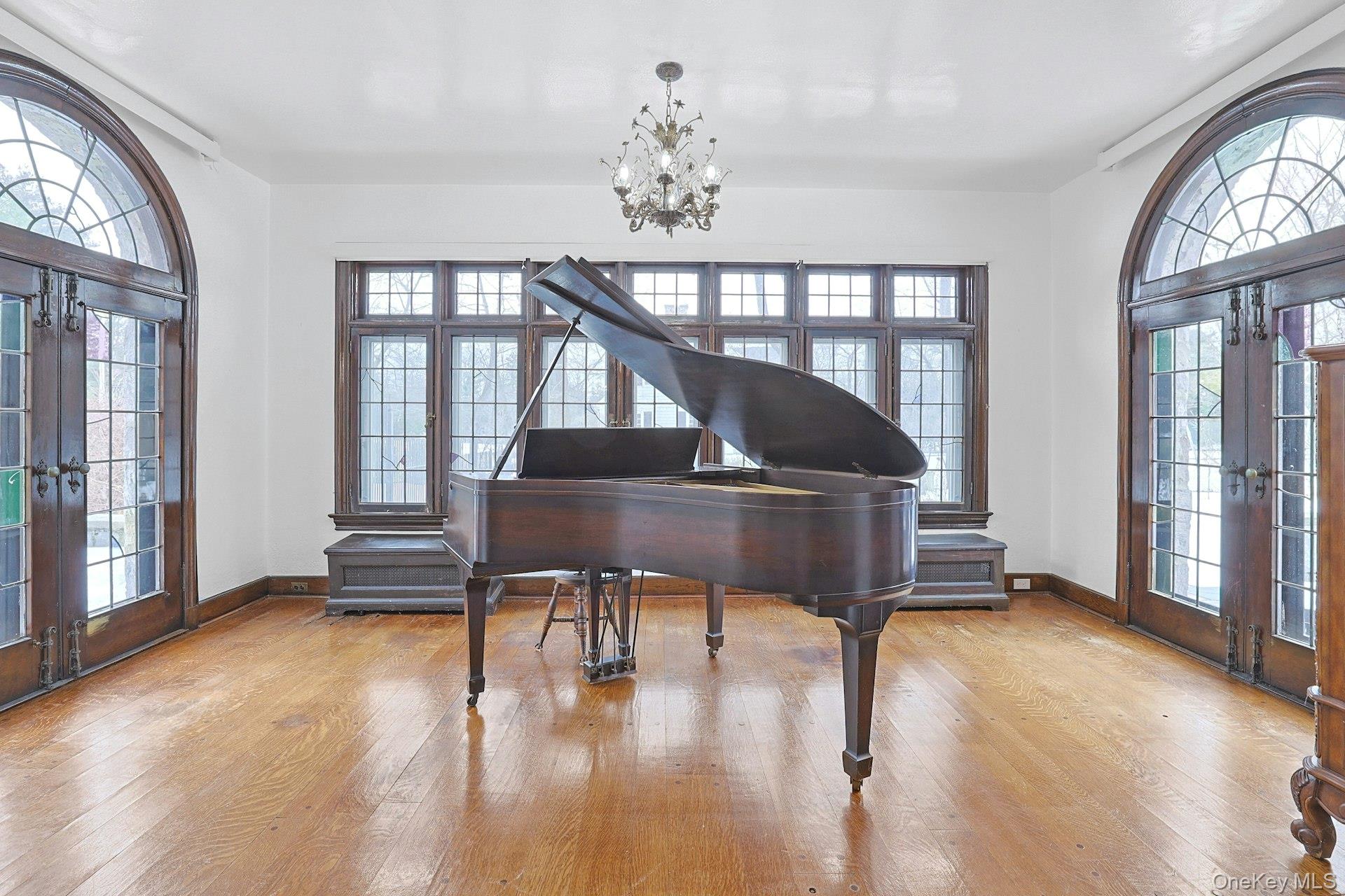 66 Mamaroneck Road Scarsdale, NY 10583 - Photo 10 of 47 A light-filled sunroom with three exposures offers a serene retreat—an ideal setting for a beautiful piano, quiet moments, or relaxed gatherings surrounded by garden views.
