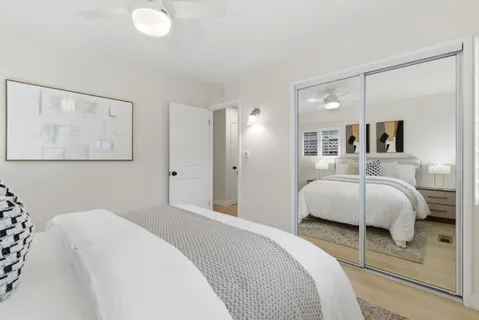 a spacious bedroom with a bed and a couch