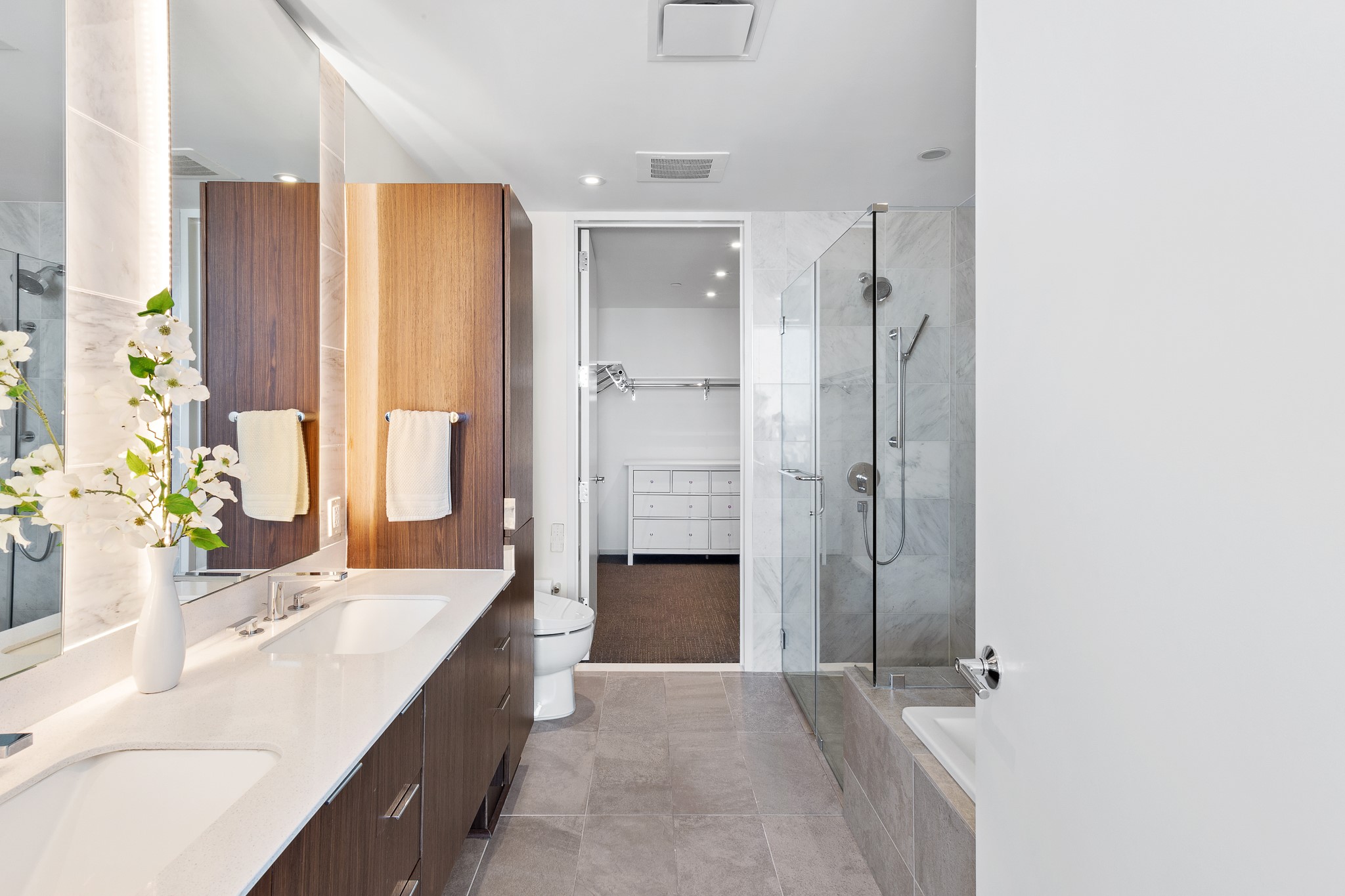 301 West Avenue, Unit 5002 Austin, TX 78701 - Photo 11 of 39 a bathroom with a double vanity sink mirror double and shower