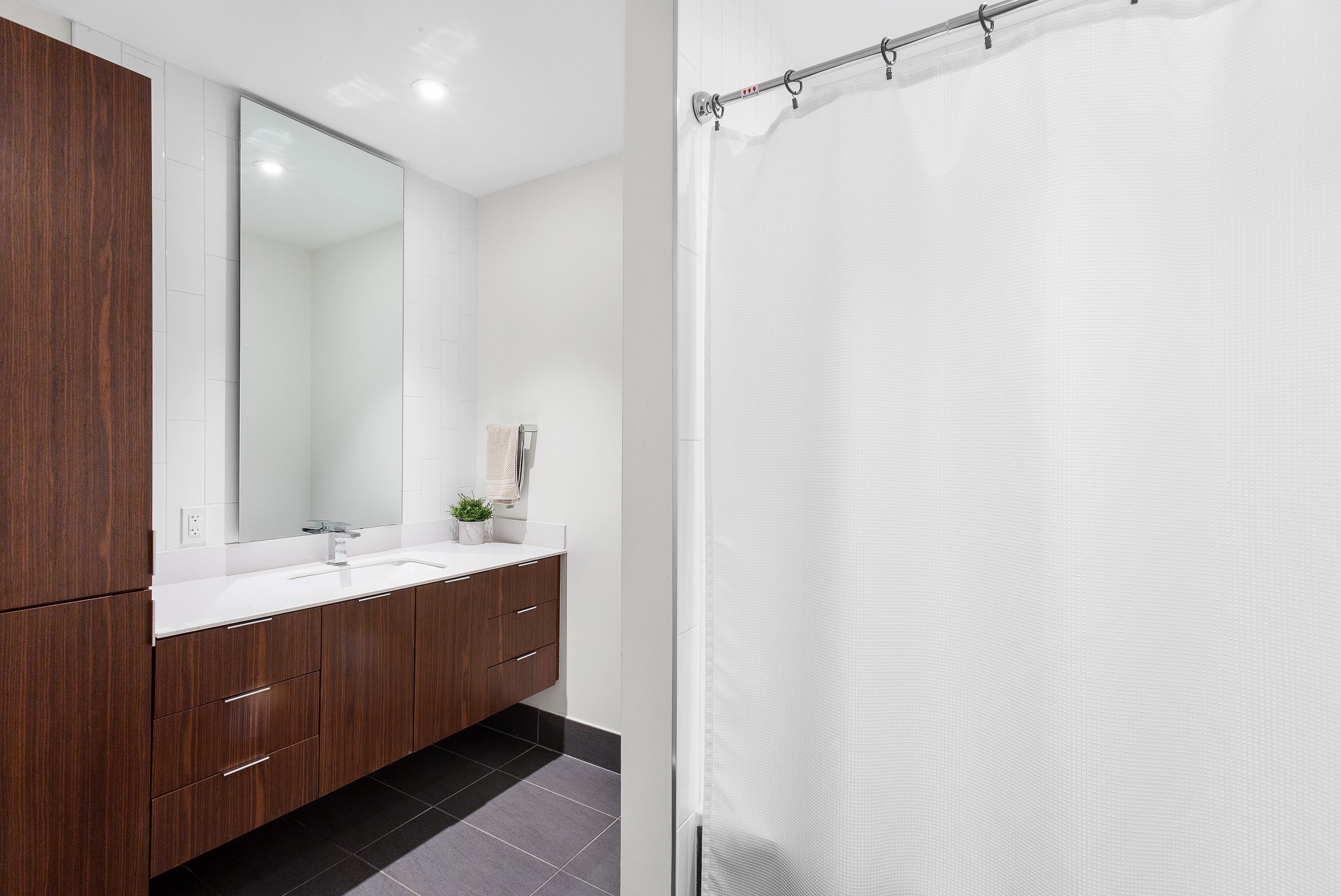 301 West Avenue, Unit 5002 Austin, TX 78701 - Photo 17 of 39 a bathroom with a double vanity sink and mirror