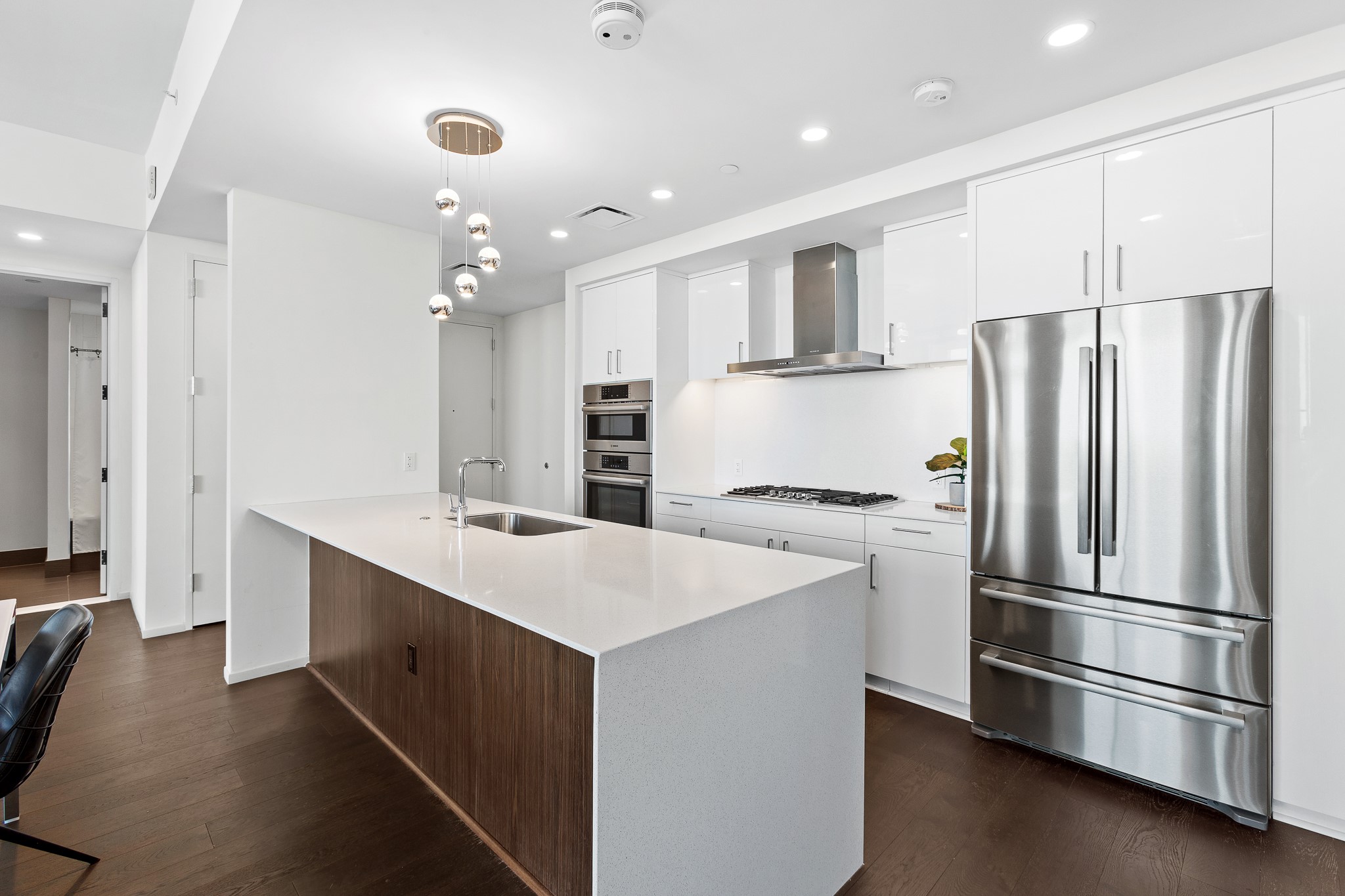 301 West Avenue, Unit 5002 Austin, TX 78701 - Photo 3 of 39 a kitchen with kitchen island a sink stainless steel appliances and cabinets