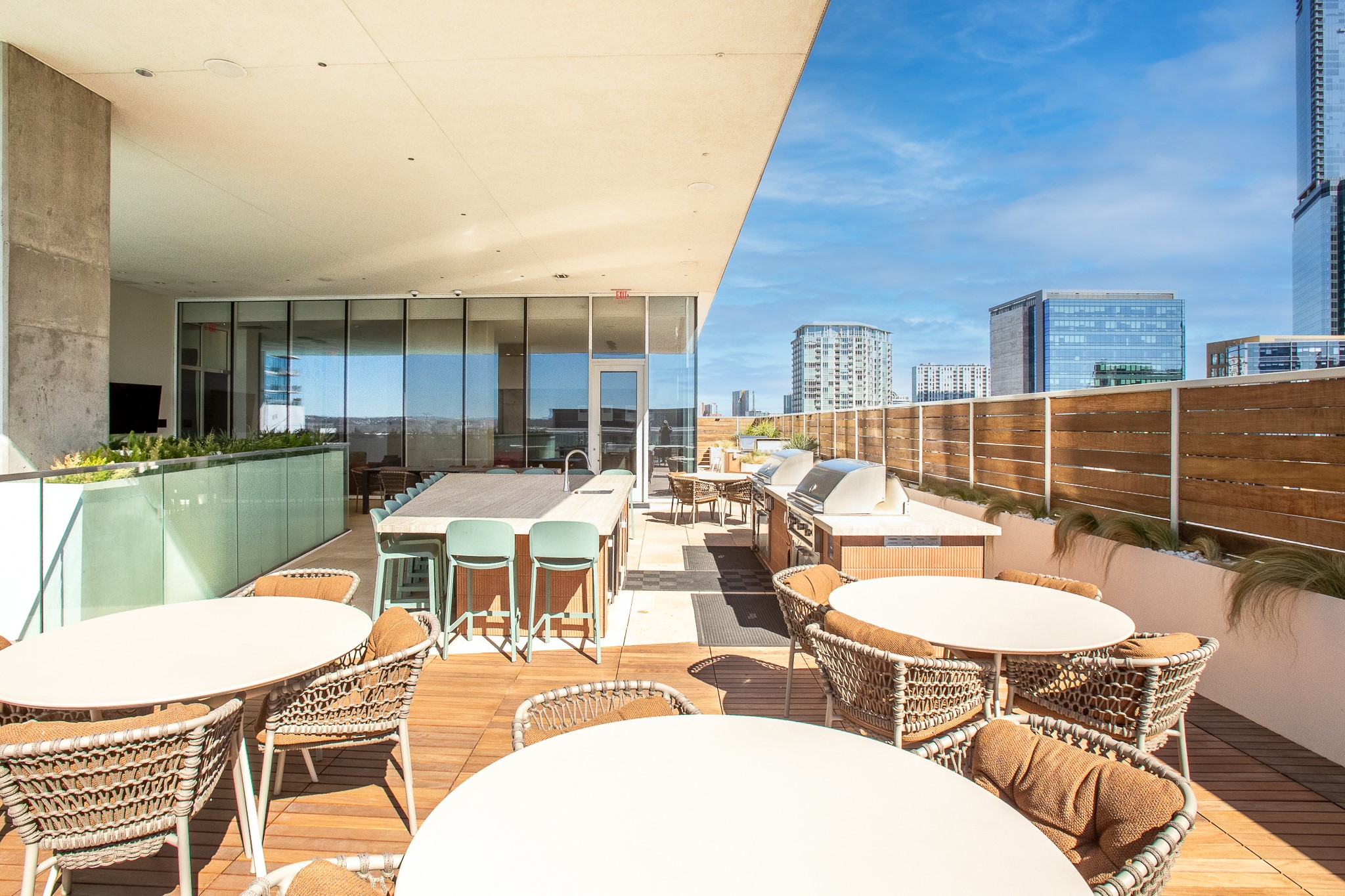 301 West Avenue, Unit 5002 Austin, TX 78701 - Photo 36 of 39 a view of a patio with table and chairs with wooden floor and fence