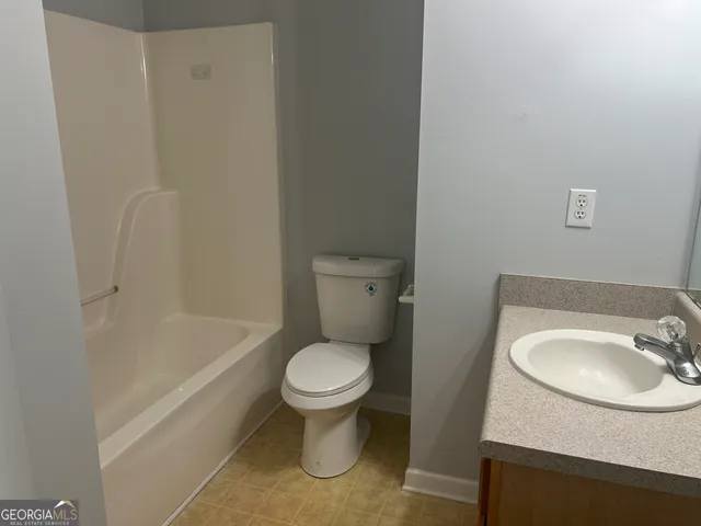 a bathroom with a sink toilet and bathtub