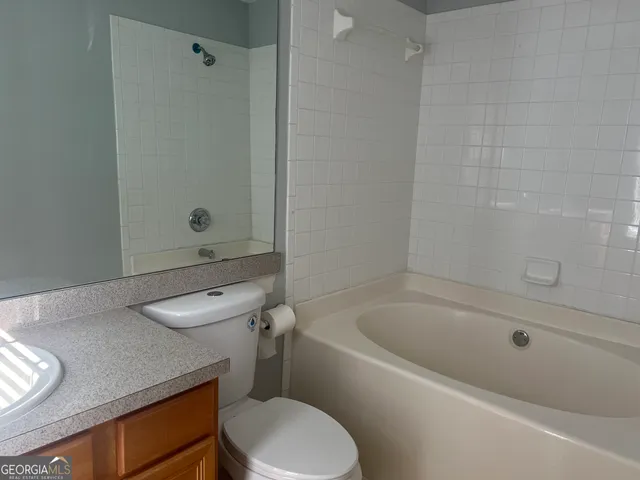 a bathroom with a sink a toilet and bathtub