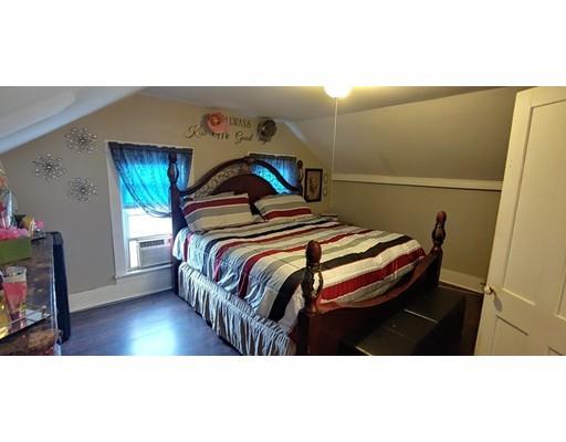 115 Allen Street Springfield, MA 01108 - Photo 16 of 21 a bedroom with a bed and a flat screen tv