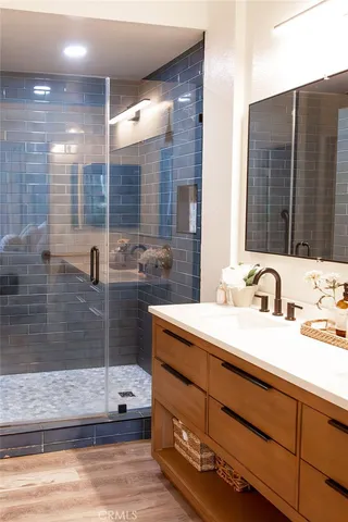a bathroom with a sink double vanity and a shower