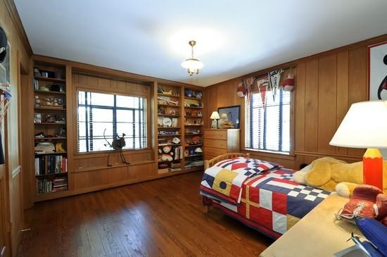 1119 Locust Road Wilmette, IL 60091 - Photo 18 of 25 a bedroom with a bed and wooden floor
