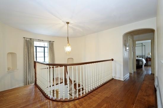 1119 Locust Road Wilmette, IL 60091 - Photo 22 of 25 a view of a hallway with wooden floor and stairs