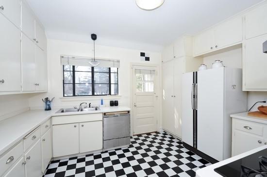 1119 Locust Road Wilmette, IL 60091 - Photo 6 of 25 a kitchen with a sink a refrigerator and cabinets