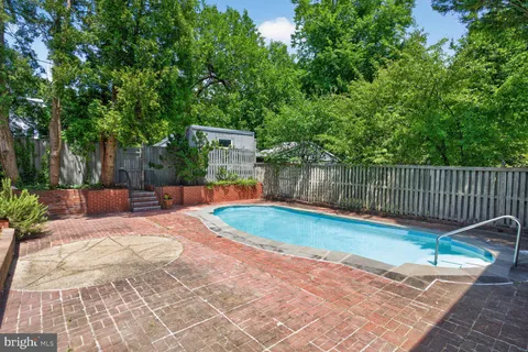 a view of a backyard with swimming pool