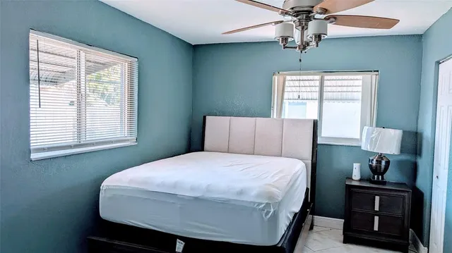 a bedroom with a bed and window