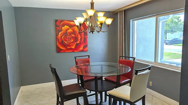 a dining room with furniture and window