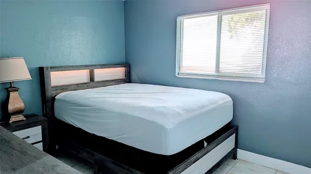 a bedroom with a bed and a window