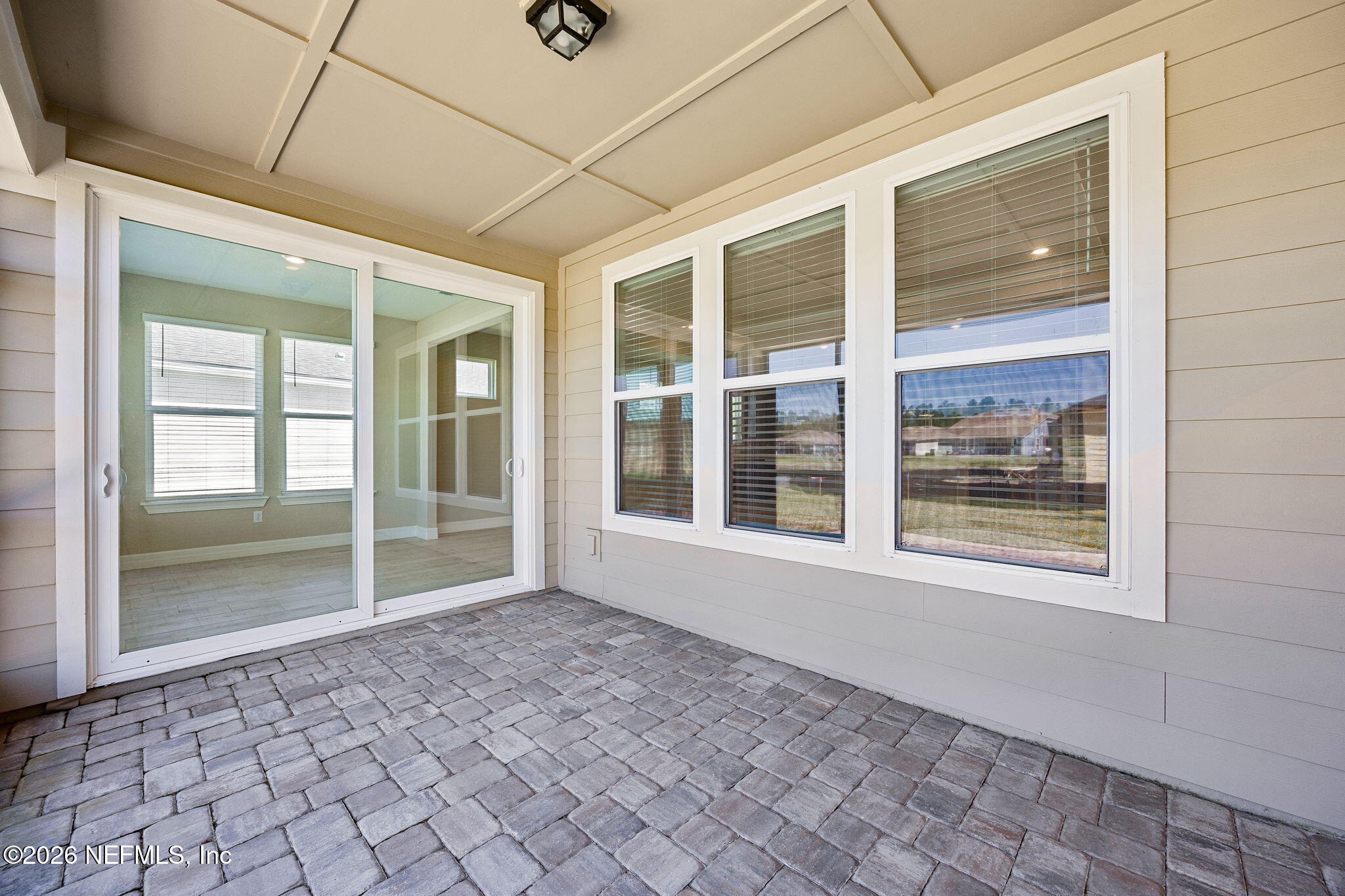 729 Continuum Loop Yulee, FL 32097 - Photo 35 of 55 Enjoy coffee or drinks on the lanai.