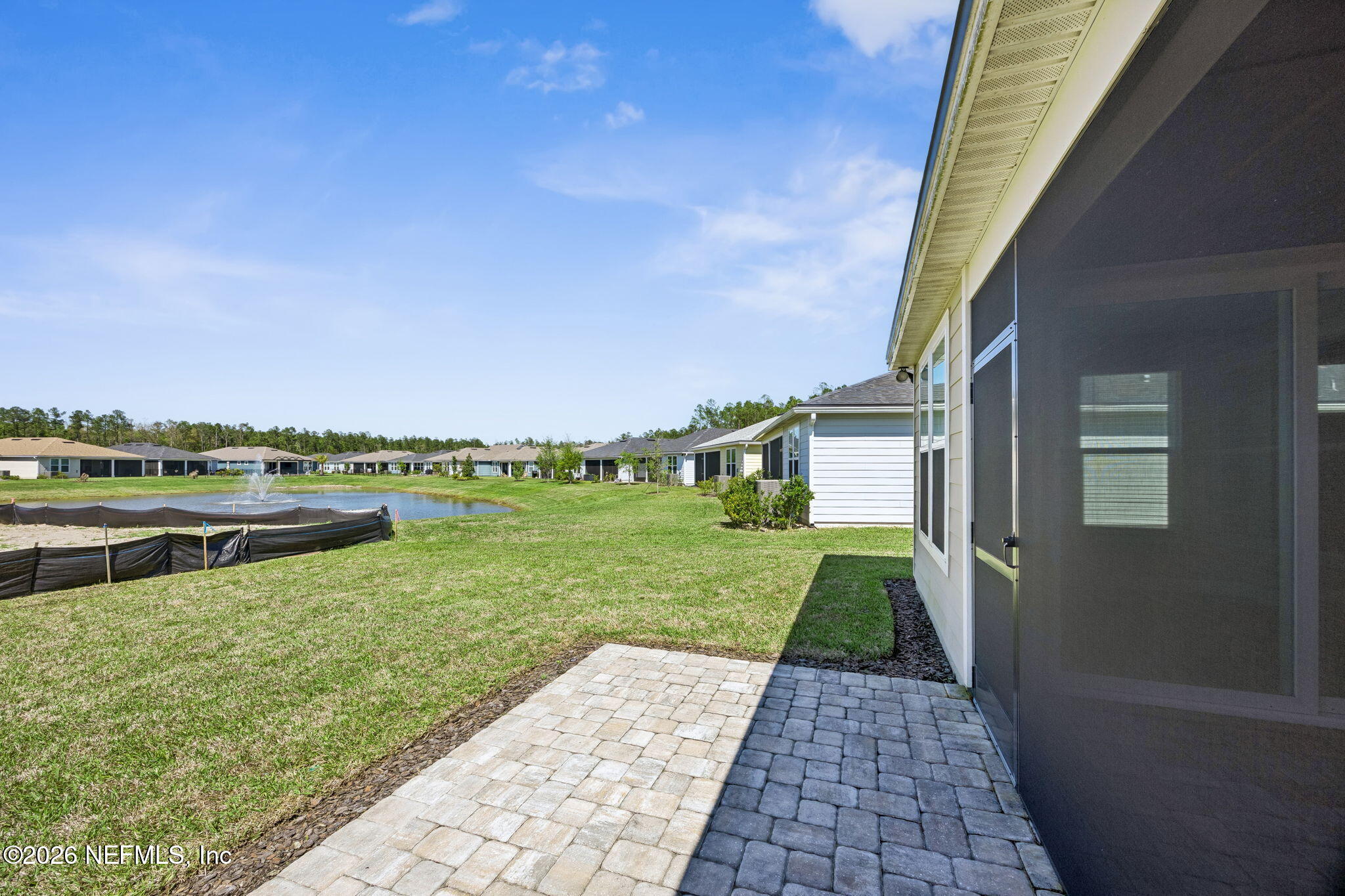 729 Continuum Loop Yulee, FL 32097 - Photo 38 of 55 Extended Paver Patio with Pond View.