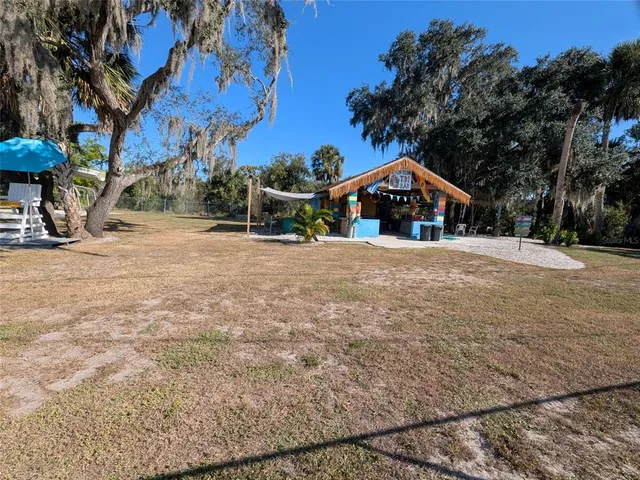 a backyard of a house with table and chairs