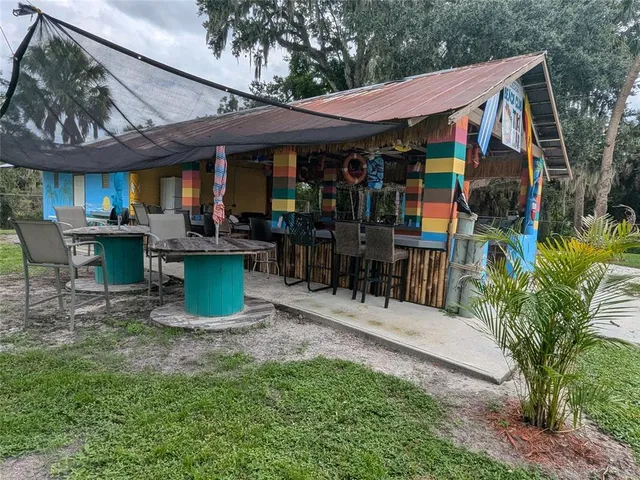 a backyard of a house with lots of green space and lake view