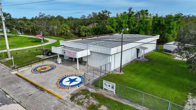 an aerial view of a tennis ground and a large pool