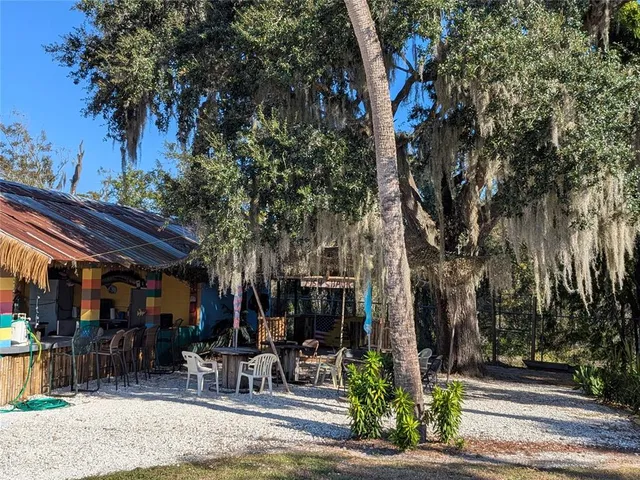 an aerial view of a houses with a yard and lake view