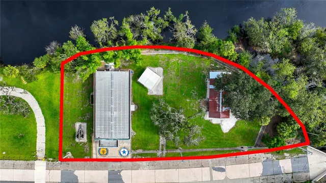 an aerial view of a house with a yard