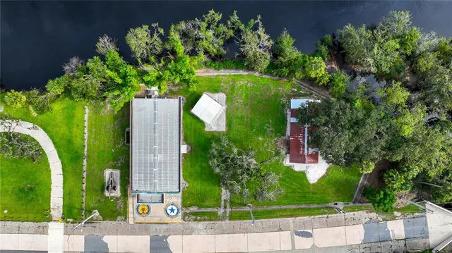 a view of a house with a yard and a patio