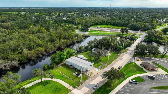 a view of a cafe with a table and chairs under an umbrella
