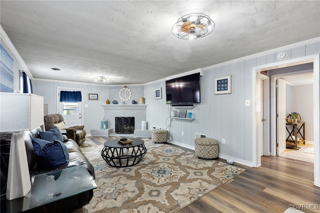 8119 Inca Court North Chesterfield, VA 23237 - Photo 23 of 36 a living room with furniture a flat screen tv and a fireplace