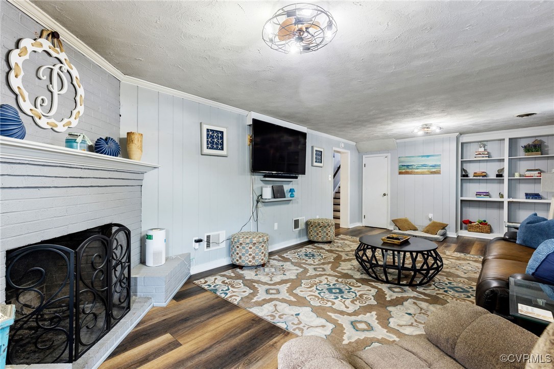 8119 Inca Court North Chesterfield, VA 23237 - Photo 25 of 36 a living room with furniture a flat screen tv and a fireplace