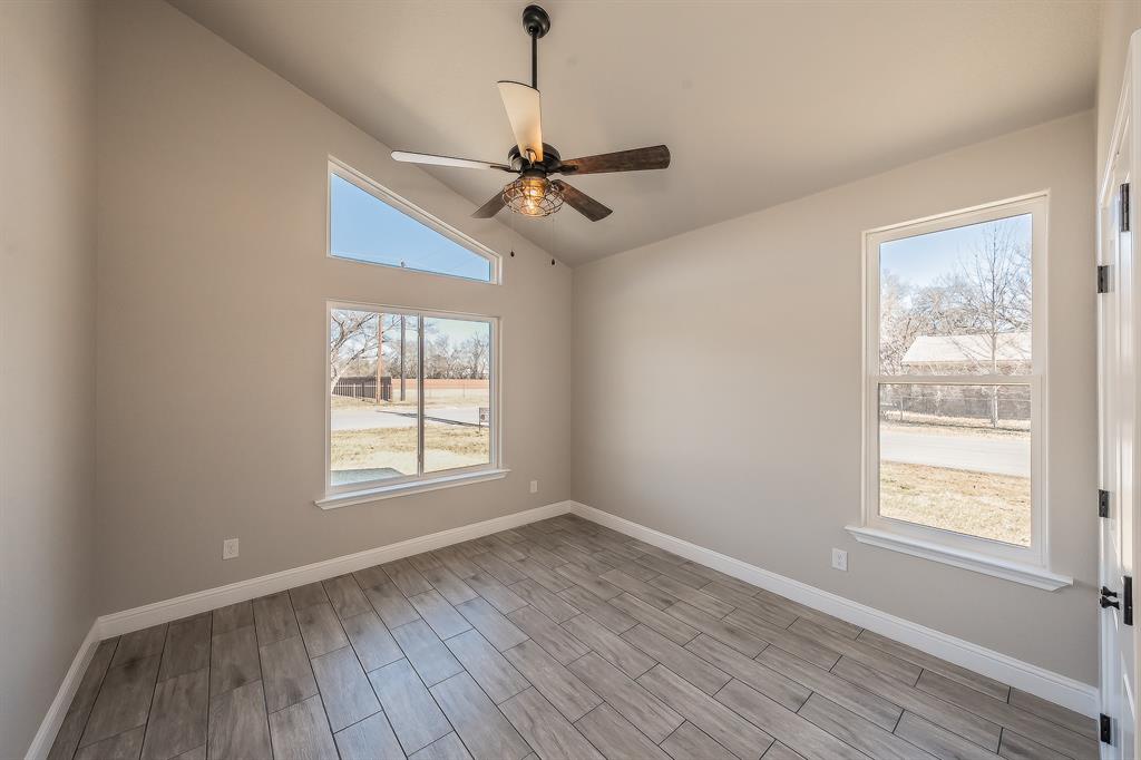 112 Stevens Street Bridgeport, TX 76426 - Photo 12 of 37 a view of an empty room with wooden floor and a window