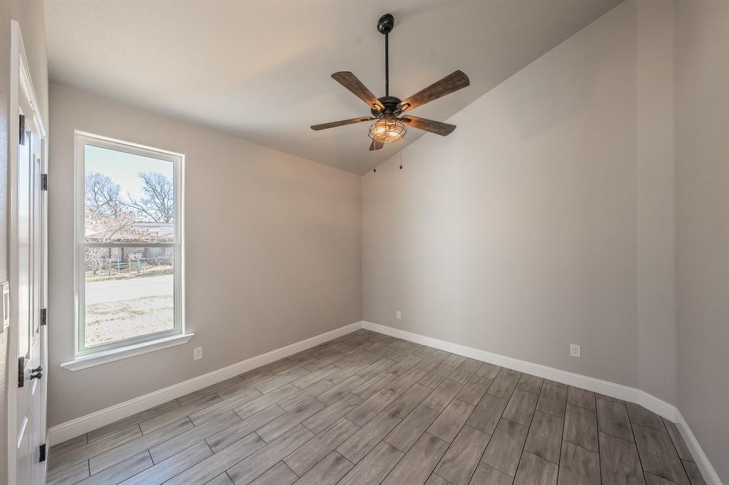 112 Stevens Street Bridgeport, TX 76426 - Photo 17 of 37 wooden floor in an empty room with a window