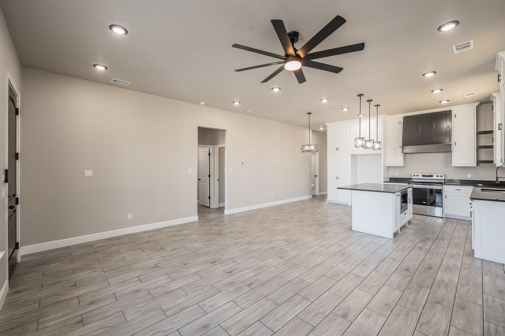 112 Stevens Street Bridgeport, TX 76426 - Photo 5 of 37 a view of kitchen with cabinets and wooden floor