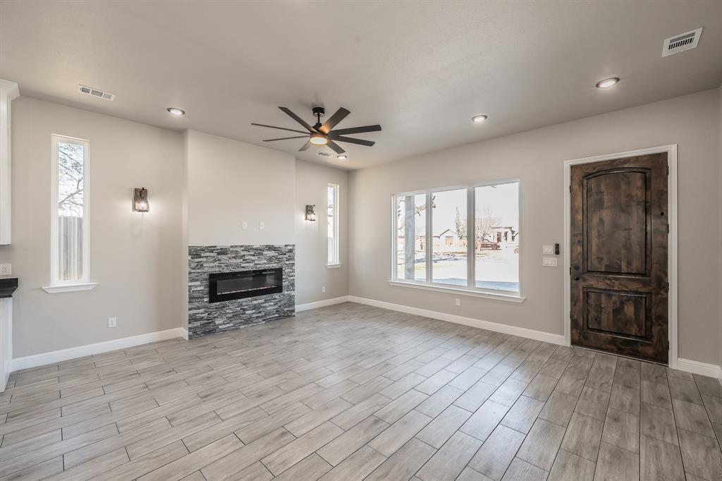 112 Stevens Street Bridgeport, TX 76426 - Photo 7 of 37 a view of an empty room with a window and fireplace