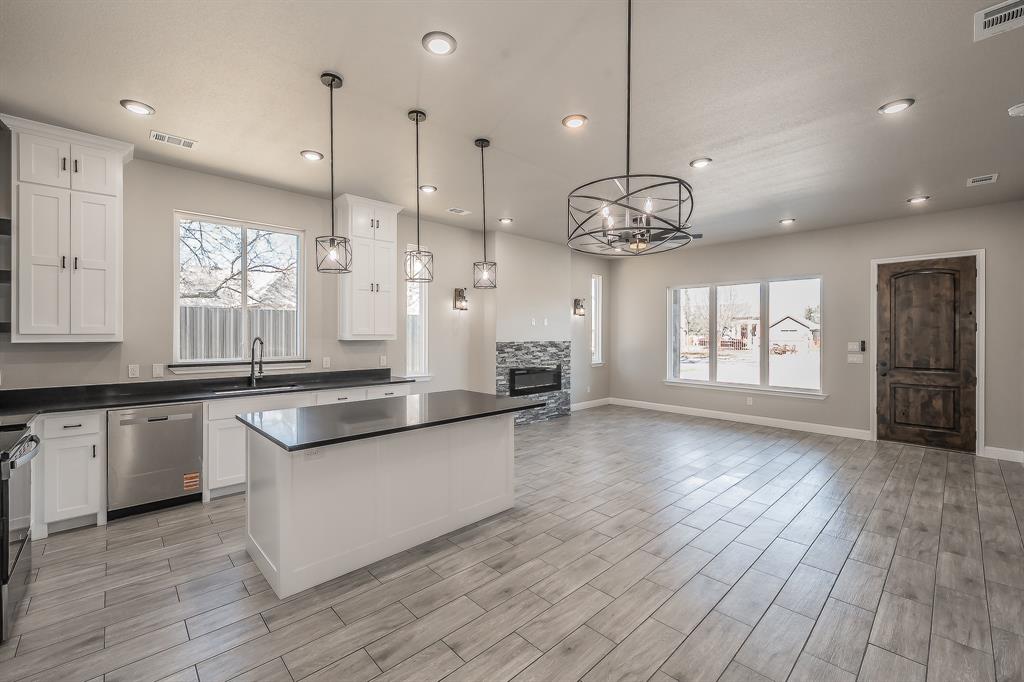 112 Stevens Street Bridgeport, TX 76426 - Photo 9 of 37 a large kitchen with lots of counter space a sink appliances and living room view