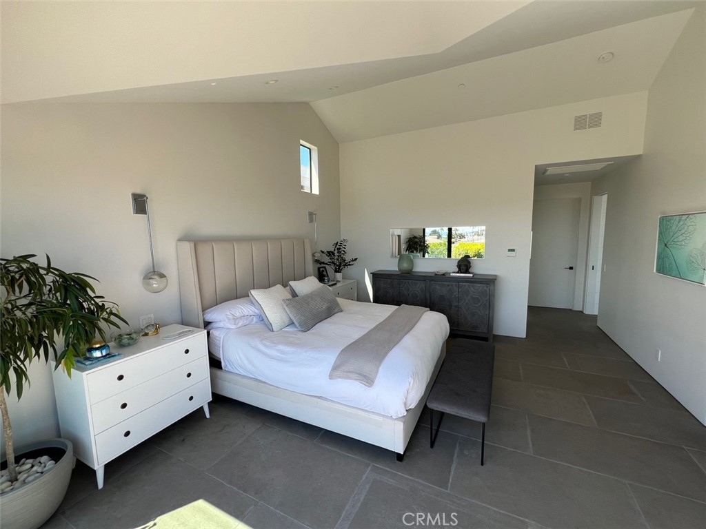 809 Emerald Bay Laguna Beach, CA 92651 - Photo 13 of 31 a bedroom with a bed and a potted plant