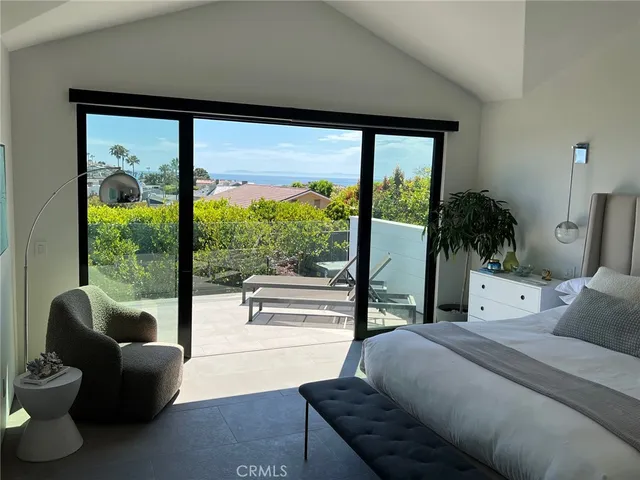 a bedroom with furniture and a large window