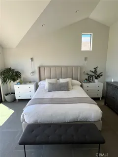 a bedroom with bed and a couch