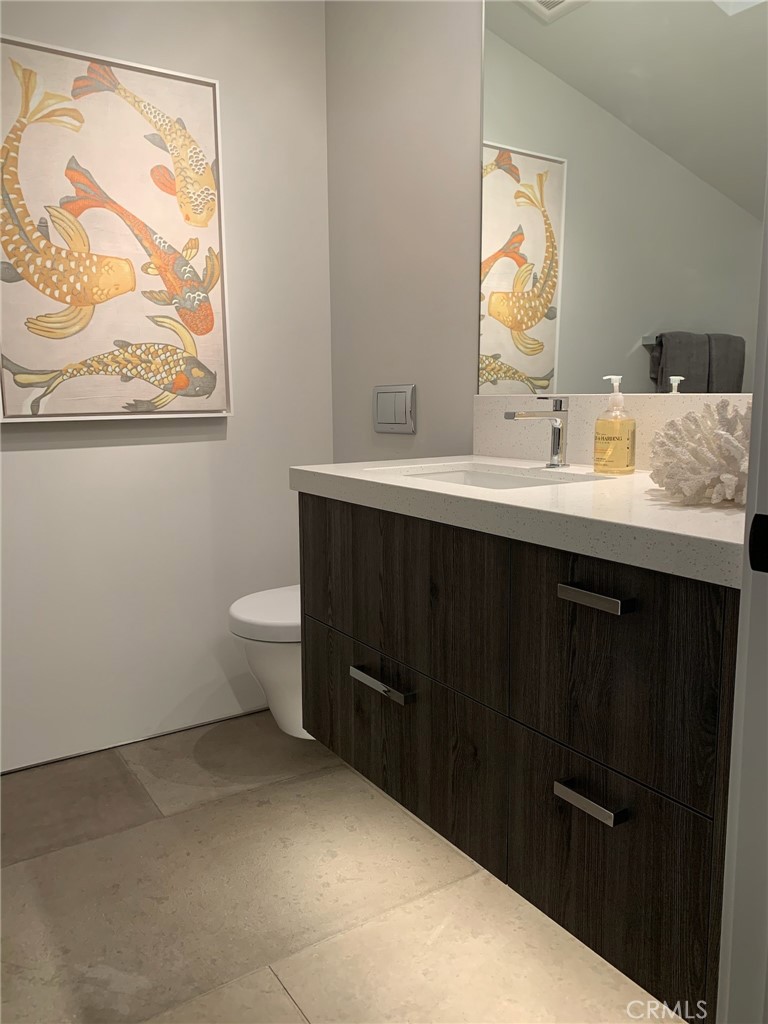 809 Emerald Bay Laguna Beach, CA 92651 - Photo 28 of 31 a bathroom with a sink mirror vanity and toilet