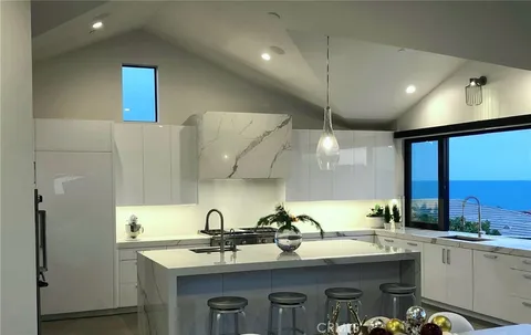 a kitchen with stainless steel appliances a sink a stove and a refrigerator