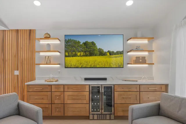 a large kitchen with kitchen island granite countertop a sink a counter space and stainless steel appliances