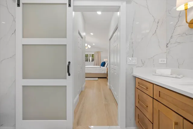 a view of entryway and hall with wooden floor