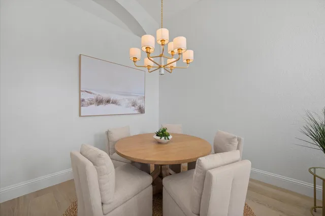 a dining room with a table and chandelier