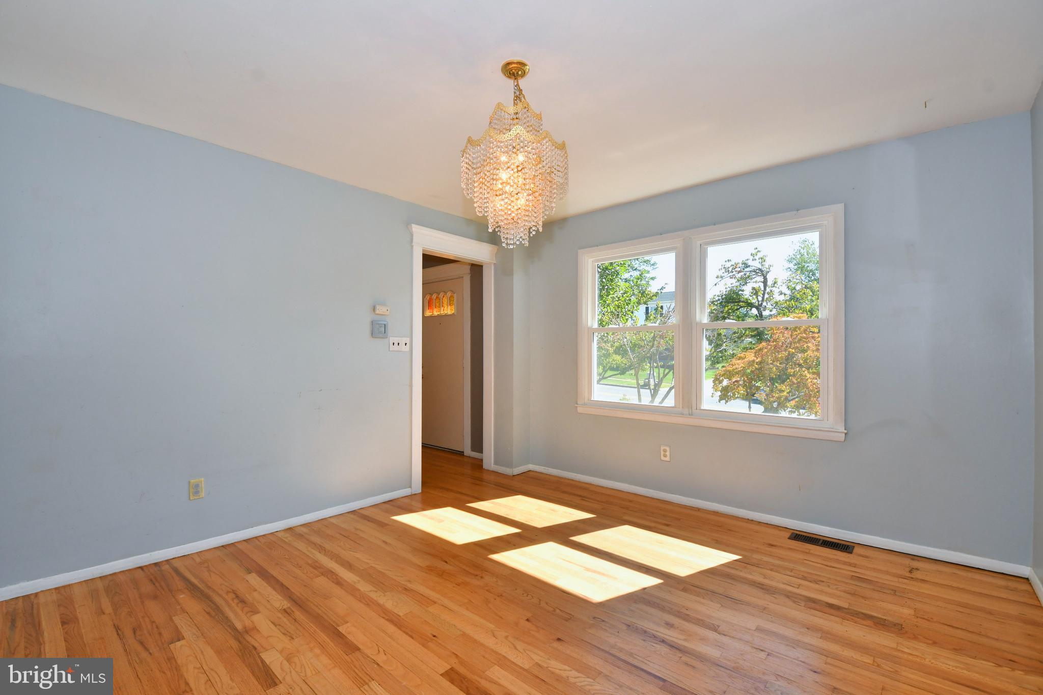 4704 Ebenezer Road Nottingham, MD 21236 - Photo 12 of 56 a view of an empty room with wooden floor and a window