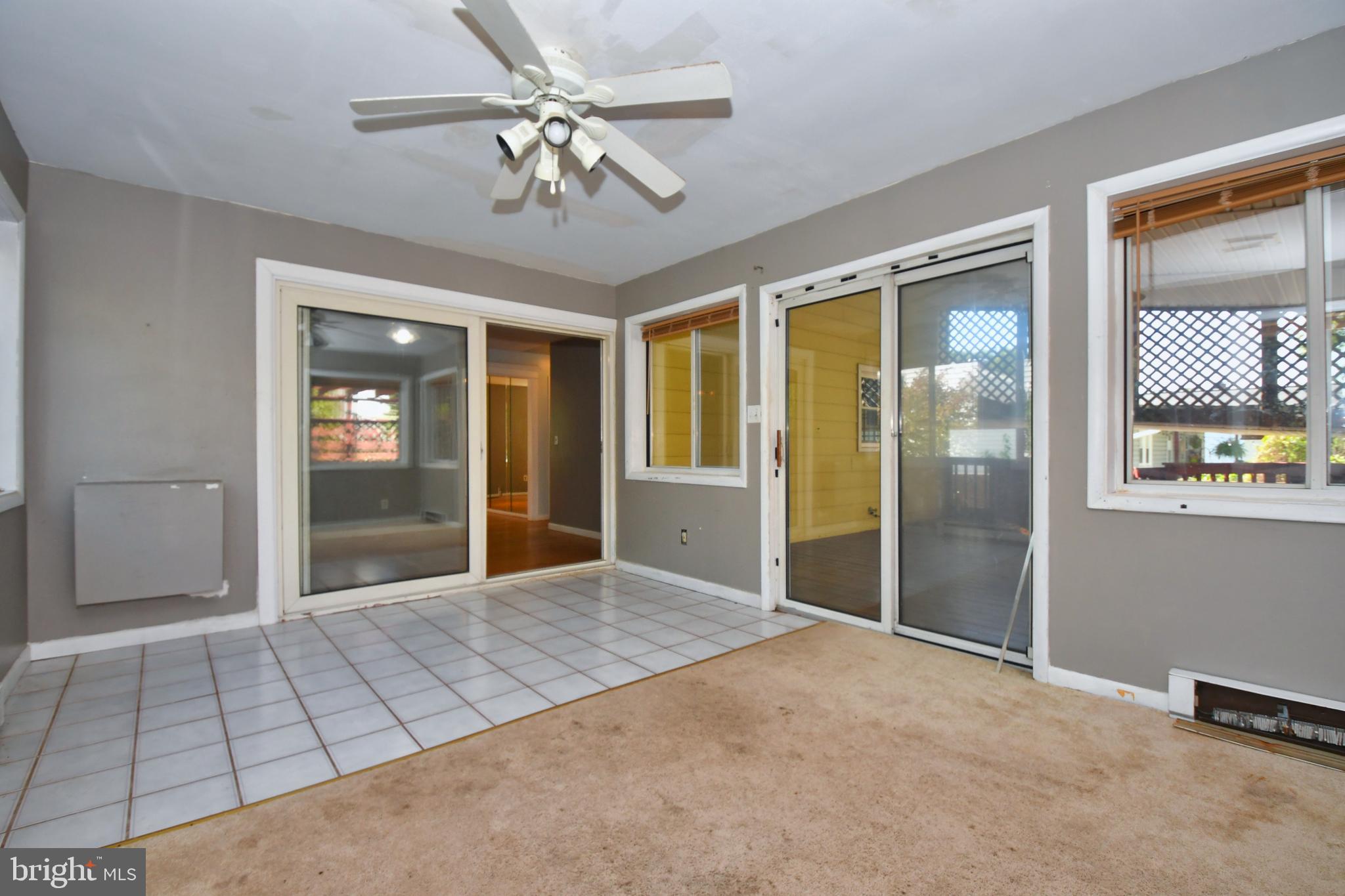 4704 Ebenezer Road Nottingham, MD 21236 - Photo 15 of 56 a view of an empty room with a chandelier fan and windows